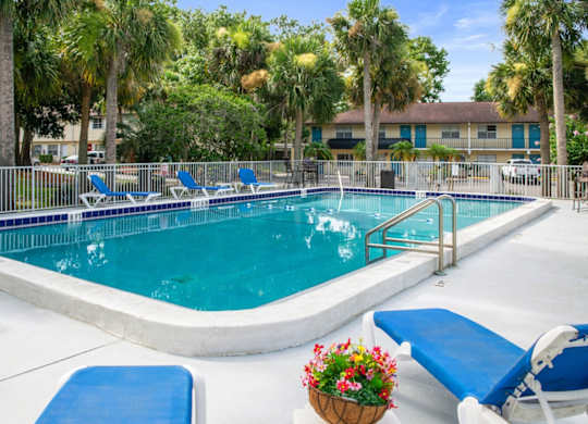 One of Ridge Apartments two sparkling swimming pools with a sundeck and lounge chairs