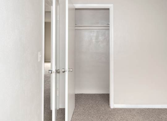 a closet with a hanging bar in a home at Park Apartments