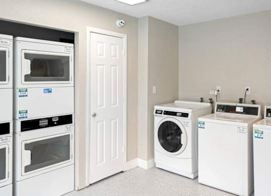 a washer and dryer in a laundry room with other appliances