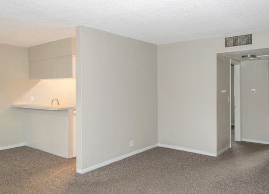 the livingroom leading to the kitchen and to the bedrooms in a park apartment home