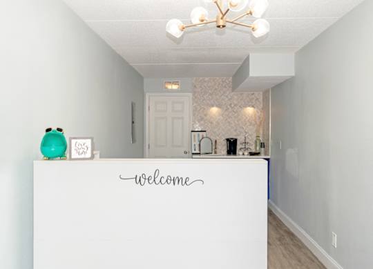 the office with a welcome desk and coffee bar at Ridge Apartments in South Daytona, FL