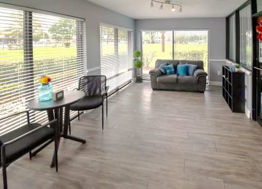 The Waterview Crossing leasing office with sitting areas, wood floors, and large windows