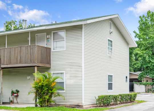 A well-kept residential building with lush landscaping at Haven on Canal Apartments in New Smyrna Beach, FL