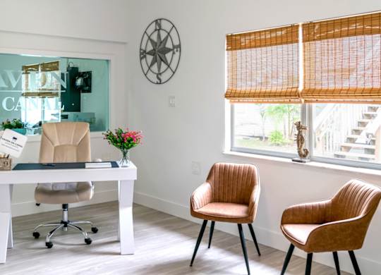 the leasing office with a desk and chair and large windows at Haven on Canal