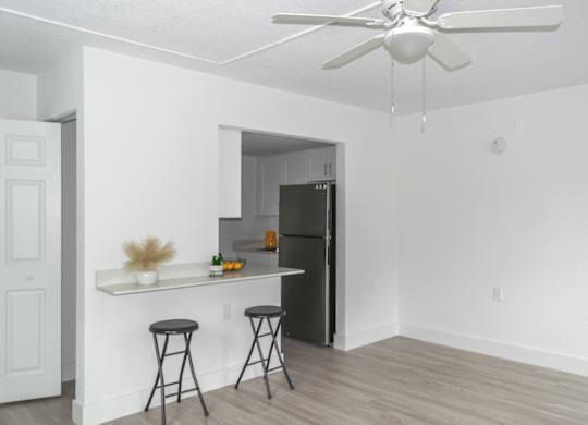 a living room with a breakfast bar and a kitchen with Stainless Steel appliances in a home at Haven on Canal Apartments