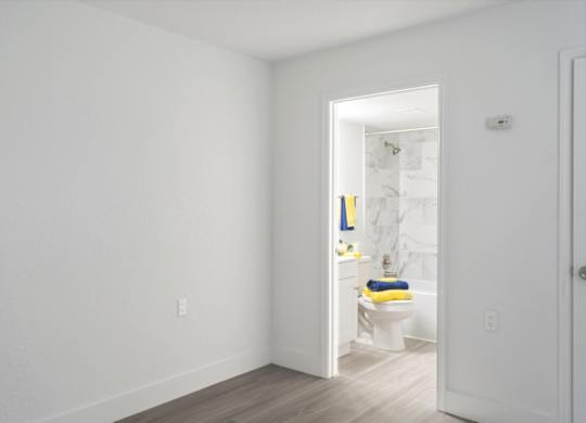 a bedroom with access to a bathroom in an apartment at Haven on Canal