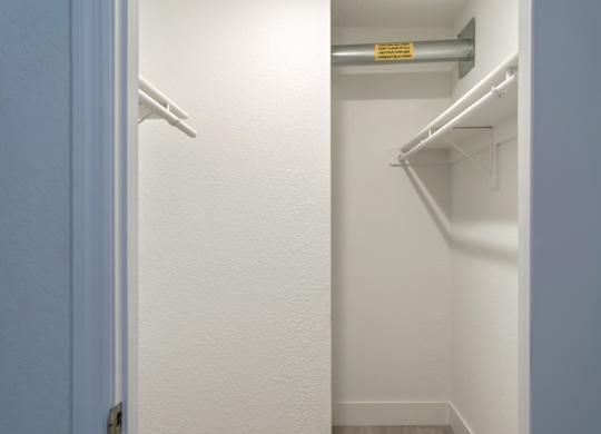 a large walk-in closet in the bedroom with built-in shelving at Haven on Canal Apartments in New Smyrna Beach, FL