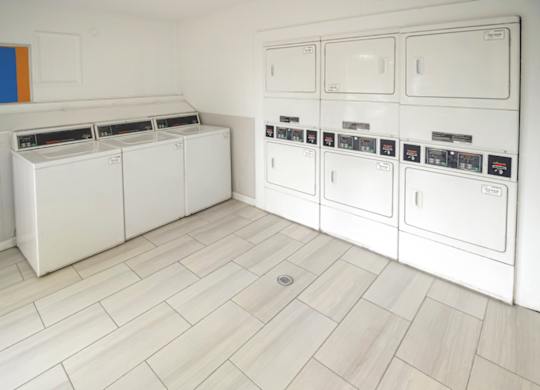 The laundry center with washers and dryers at Pine Creek Apartments