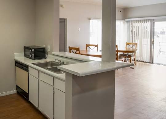 the clubhouse kitchenette with sink, microwave, and dishwasher at Pine Creek Apartments