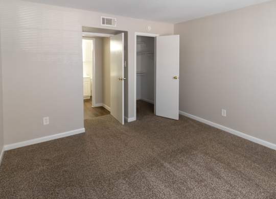 A spacious bedroom with a large closet and bathroom access