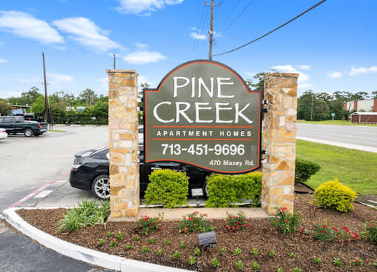 Entrance sign of Pine Creek Apartment Homes in Houston, Texas