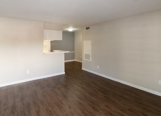 wood-inspired flooring and light walls in a residential living room at The Forest Apartments