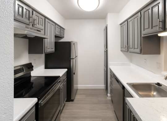a kitchen with stainless steel appliances and white counter tops and black appliances