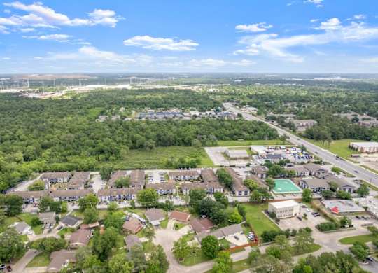 Pine Creek Apartments nestled in a lush, tree-lined area of Houston, TX
