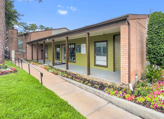 the exterior of the leasing office and clubhouse at Crosby at Westchase Apartments in Houston