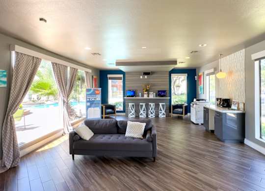 clubhouse with a couch, business center, and coffee bar at Hudson at Westchase Apartments
