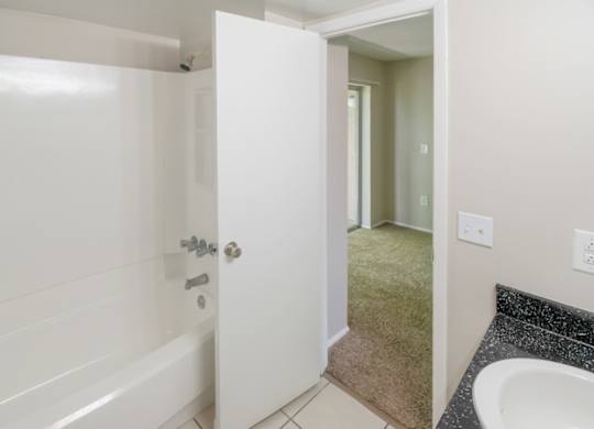 an in-home bathroom with a tub, shower, and a sink vanity