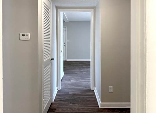 a hallway with a door and a light switch at Spring Lake Cove Apartments, Alabama, 35215