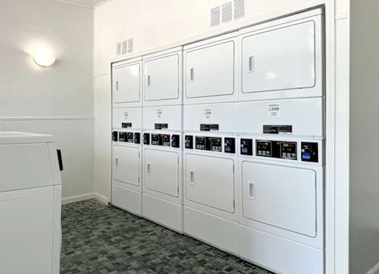 a row of white appliances in a laundry room at Spring Lake Cove Apartments, Birmingham, AL 35215