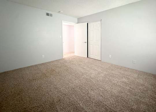 a large carpeted bedroom at Ascot Place Apartments, Alabama