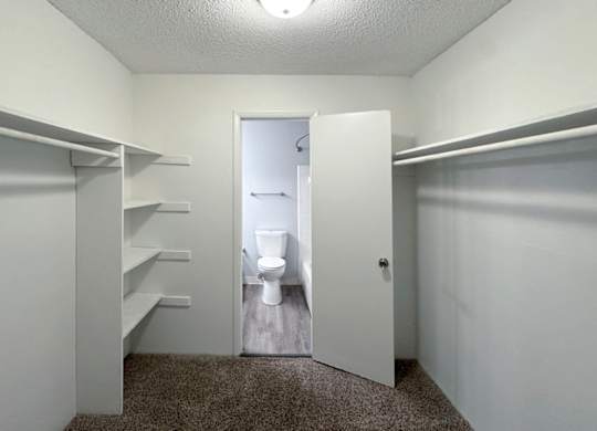 a bathroom with a toilet and a closet at Ascot Place Apartments, Birmingham, AL 35235