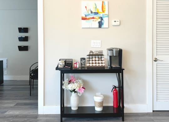 a black shelf with a coffee maker and other items on it at Spring Lake Cove Apartments, Birmingham Alabama