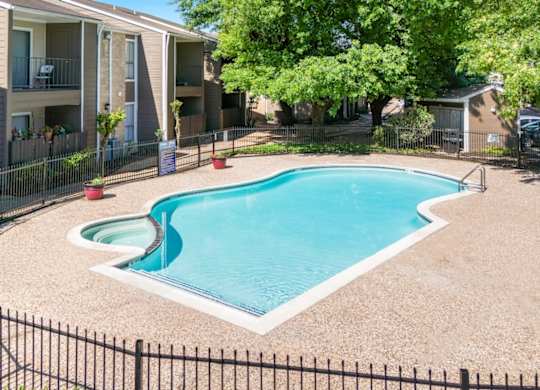 a beautiful pool and sundeck beside residential buildings at Kirkwood Landing