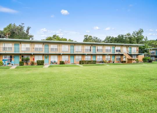 Park Apartments in Daytona Beach with a large green lawn