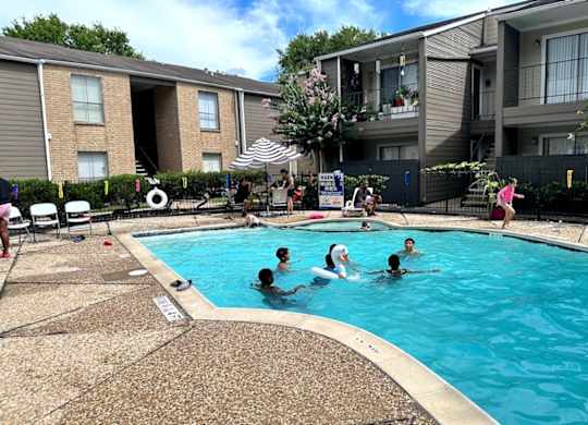 People are enjoying a sunny day at the pool.