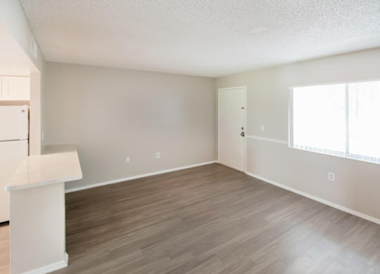 A living room and kitchen filled with natural light at Waterview Crossing Apartments