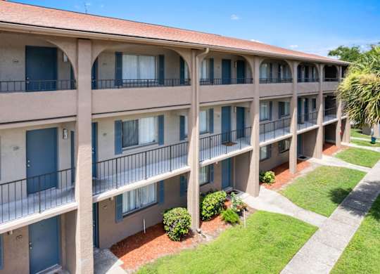 well-kept shared front balconies and lush lawns in front of residences at Waterview Crossing Apartments