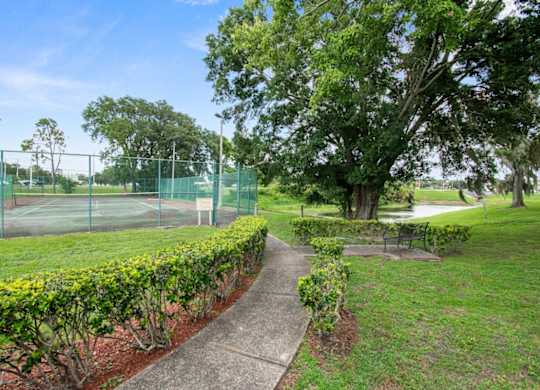 a path leading to the tennis court in at Waterview Crossing Apartments in Orlando