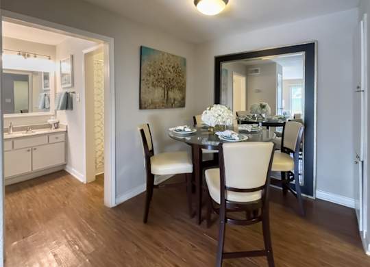 a dining area and entrance to the bathroom in a home at Waters at Westchase