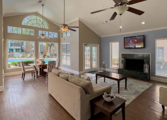 the spacious and welcoming clubhouse interior with furnishings and a tv at Waters at Westchase