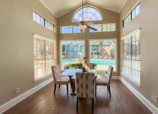 a dining area surrounded by windows overlooking the pool at Waters at Westchase