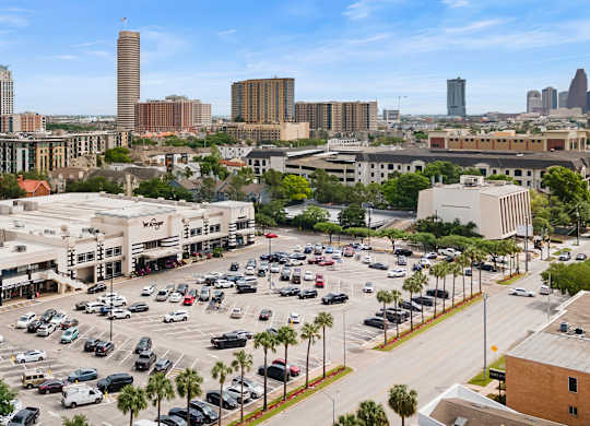 A parking lot with cars and buildings in the background.