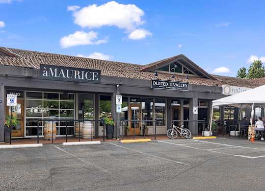 A Maurice storefront with a white tent in front.