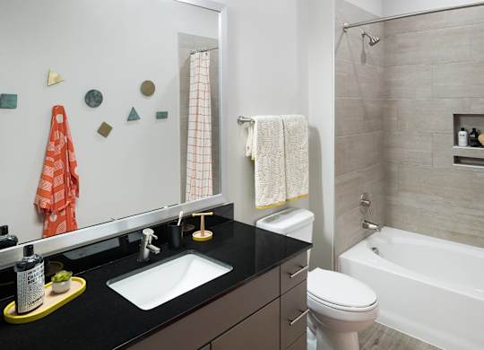 Bathroom with tub at Jada Legacy Central Apartments in Plano TX.