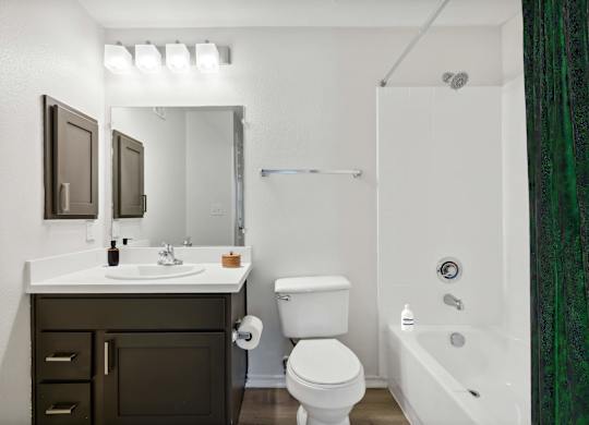 A white sink and toilet in a bathroom.