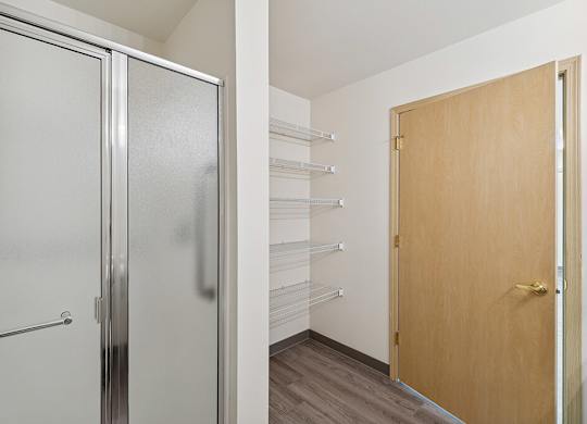 Bathroom with linen storage at Ballinger Court Senior Apartments in Edmonds WA
