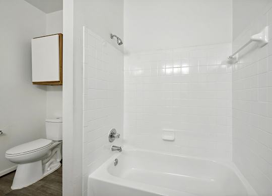 Bathroom with white tile at Fountains at Tidwell and The Enclave in Houston TX
