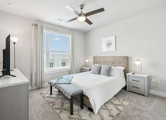 Bedroom with ceiling fan at The Sevens in Dallas TX