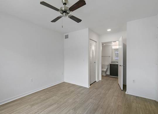 Bedroom with attached bathroom at Brenton at Abbey Park Apartments in West Palm Beach FL
