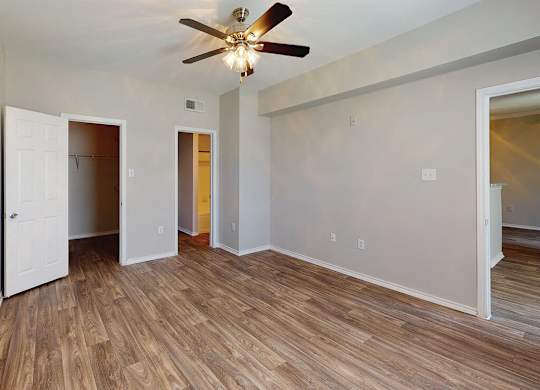Bedroom with ceiling fan at Kensley Apartment Homes in Irving TX