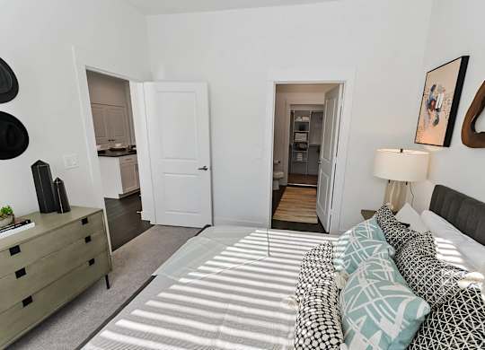 Bedroom with attached bathroom and closet at Opal Legacy Central in Plano TX