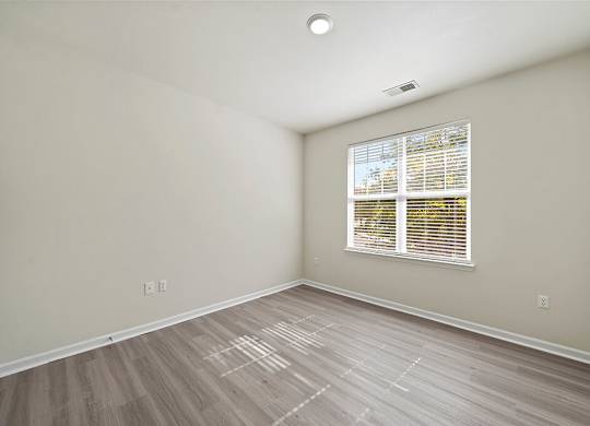 Bedroom with window at Grand Oaks Apartments in Chester VA