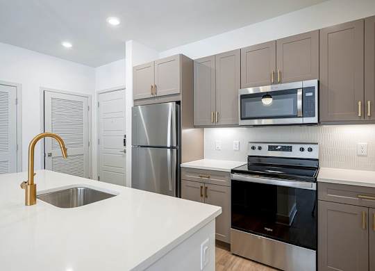 Brass Design Package Kitchen Island at The Belhaven Apartments  in Alexandria, VA