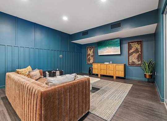 A bedroom with a bed, a bench, and a painting on the wall.
