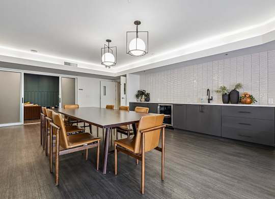 A dining room with a table and chairs.