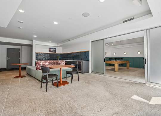 A modern dining room with a glass table and chairs.